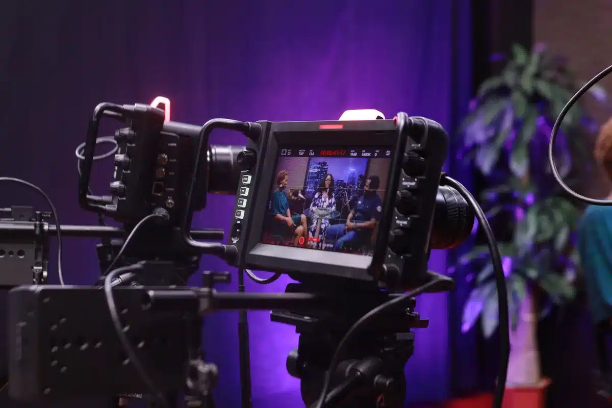 Woman on set during an emotional television interview, showing composure and strength