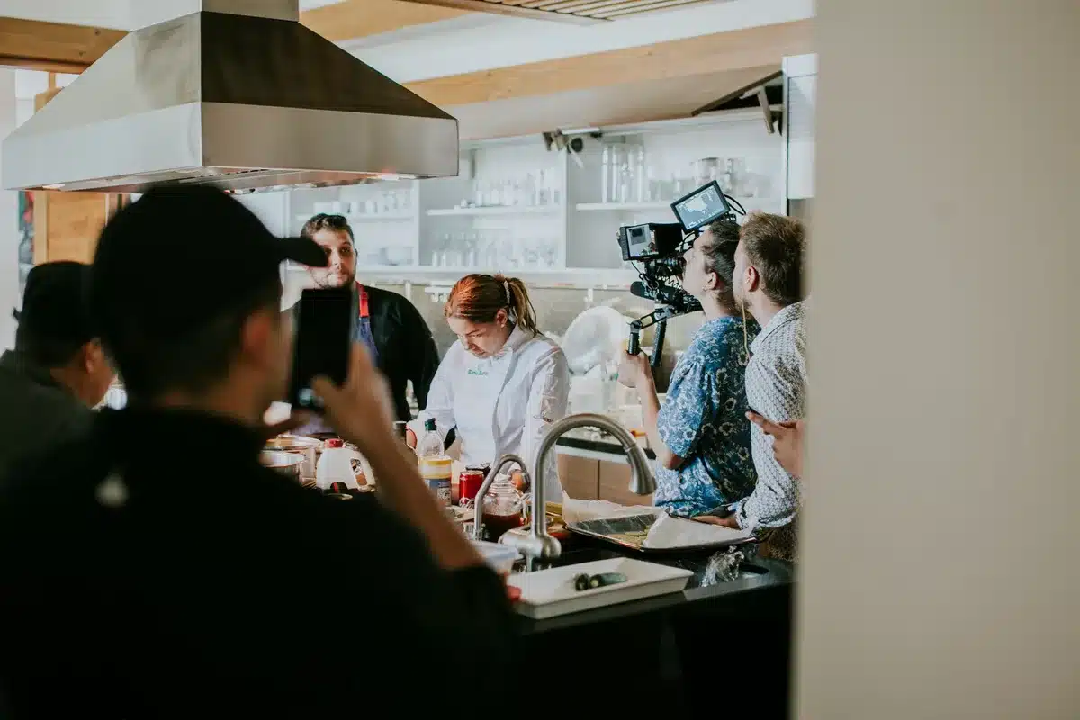 Television production crew and cast members on set, offering emotional support during filming