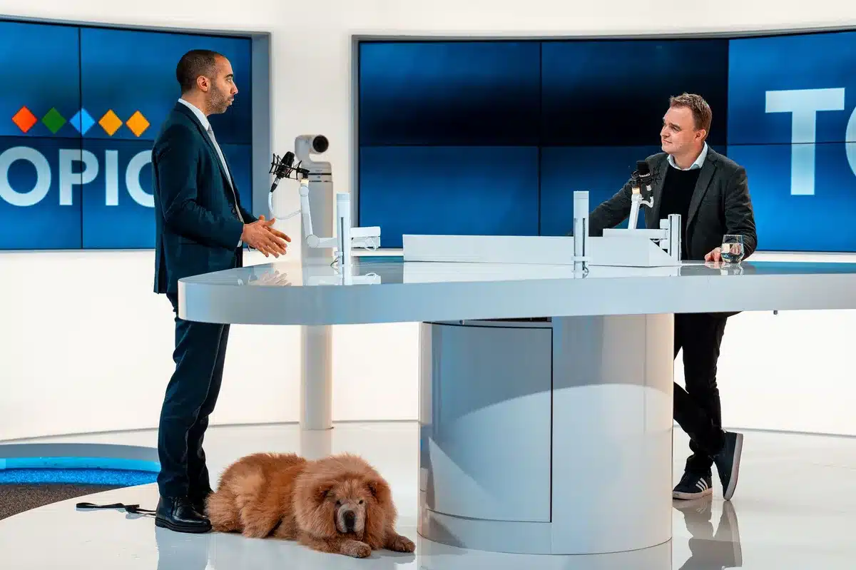 Television studio setting with hosts discussing news at a morning show desk
