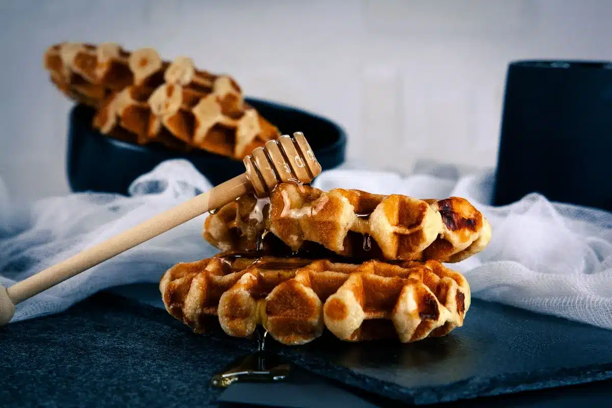 Belgian street food scene with craft beer and waffles at night