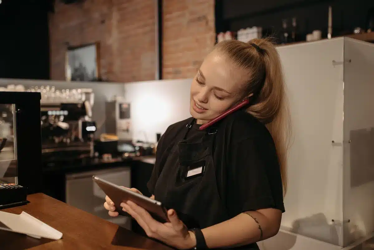 Person using a smartphone to place a café order and track rewards in real-time