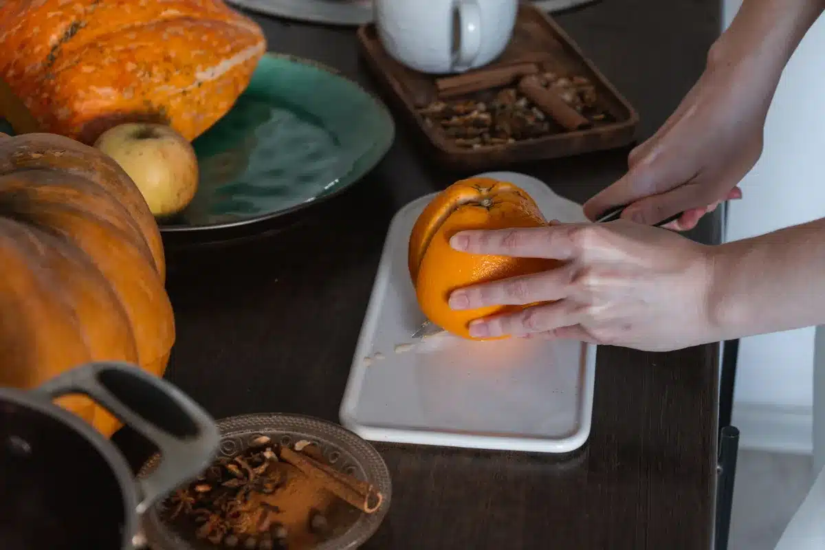 Ingredients and preparation of homemade pumpkin spice latte with frother and spices