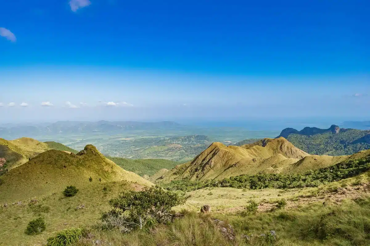 Panoramic view of Panama's diverse landscapes: misty mountains, tropical forest, and coastal beaches in one frame