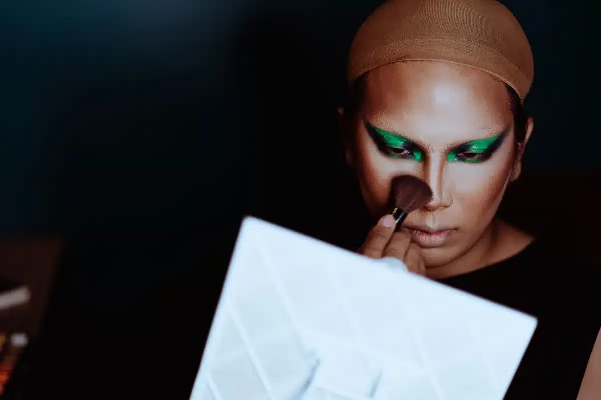 Makeup artist demonstrating contouring technique on face