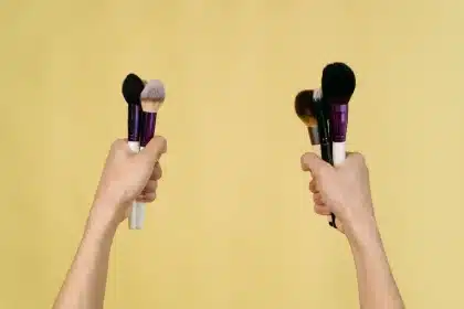 Makeup artist applying contour with precision brush on anonymous face with soft lighting