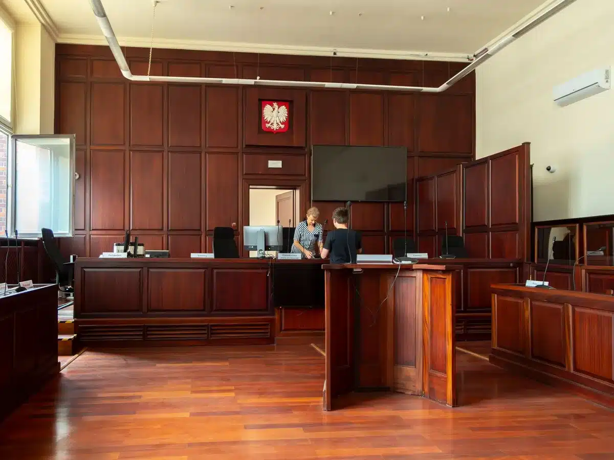 Interior of a federal courtroom with judge's bench and legal proceedings underway