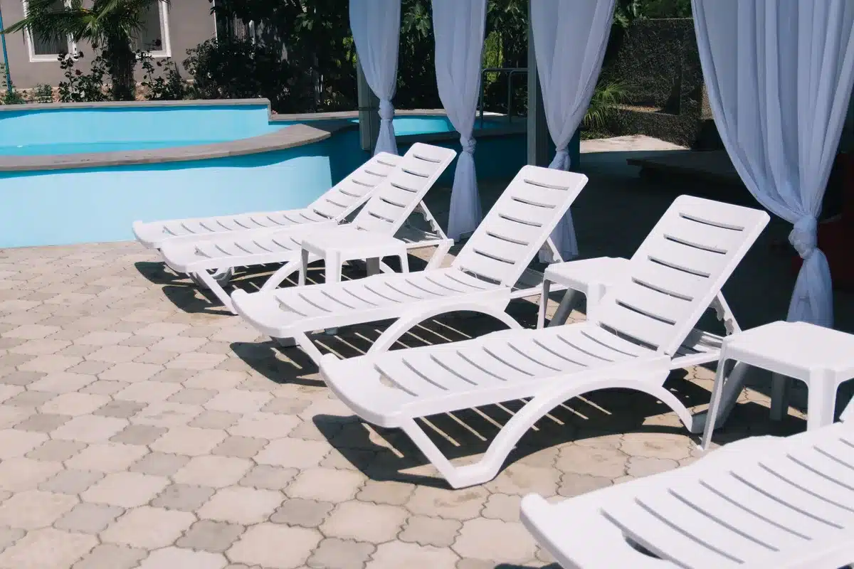 Outdoor pool and furniture displayed in a backyard setting