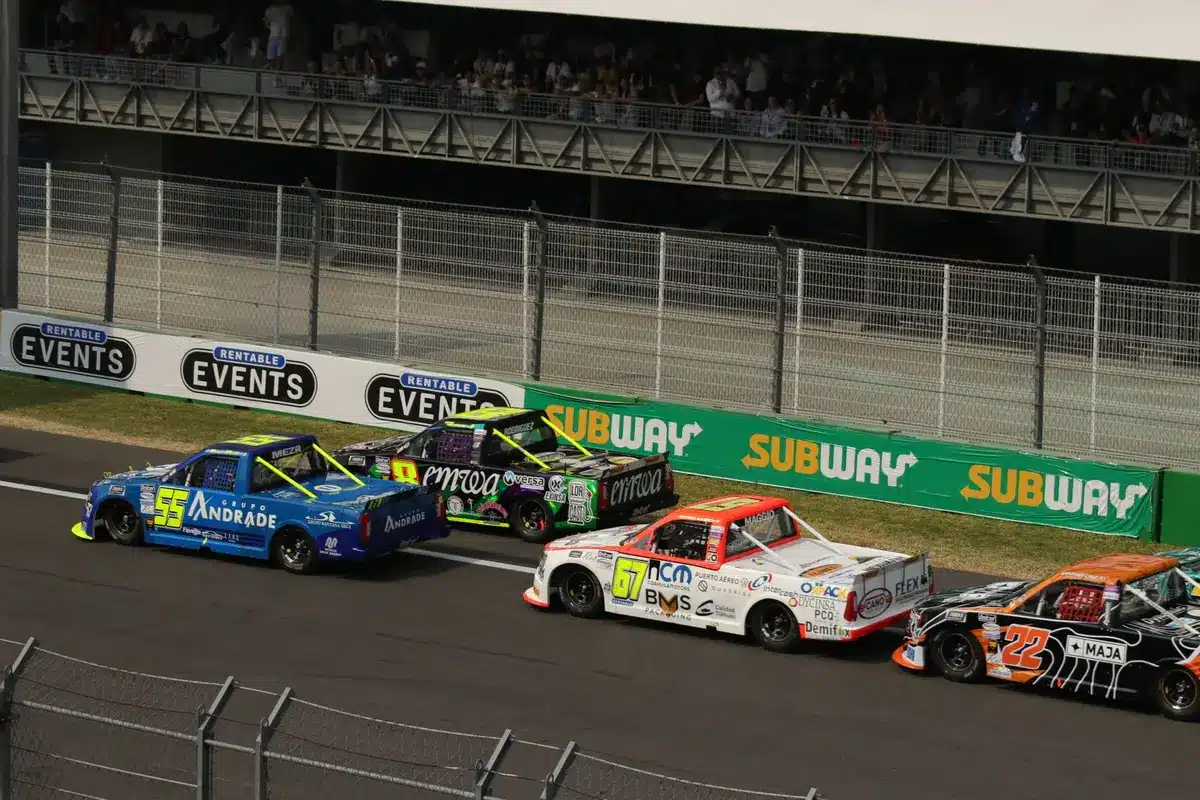 NASCAR racing action with spectators in grandstands