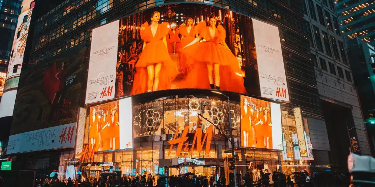 Digital screens displaying advertising and promotional content in a modern retail or entertainment venue