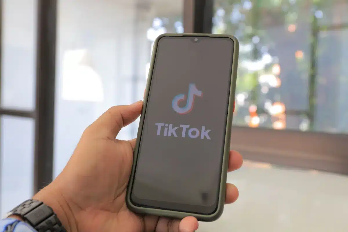 Smartphone showing social media app with viral content and user reactions