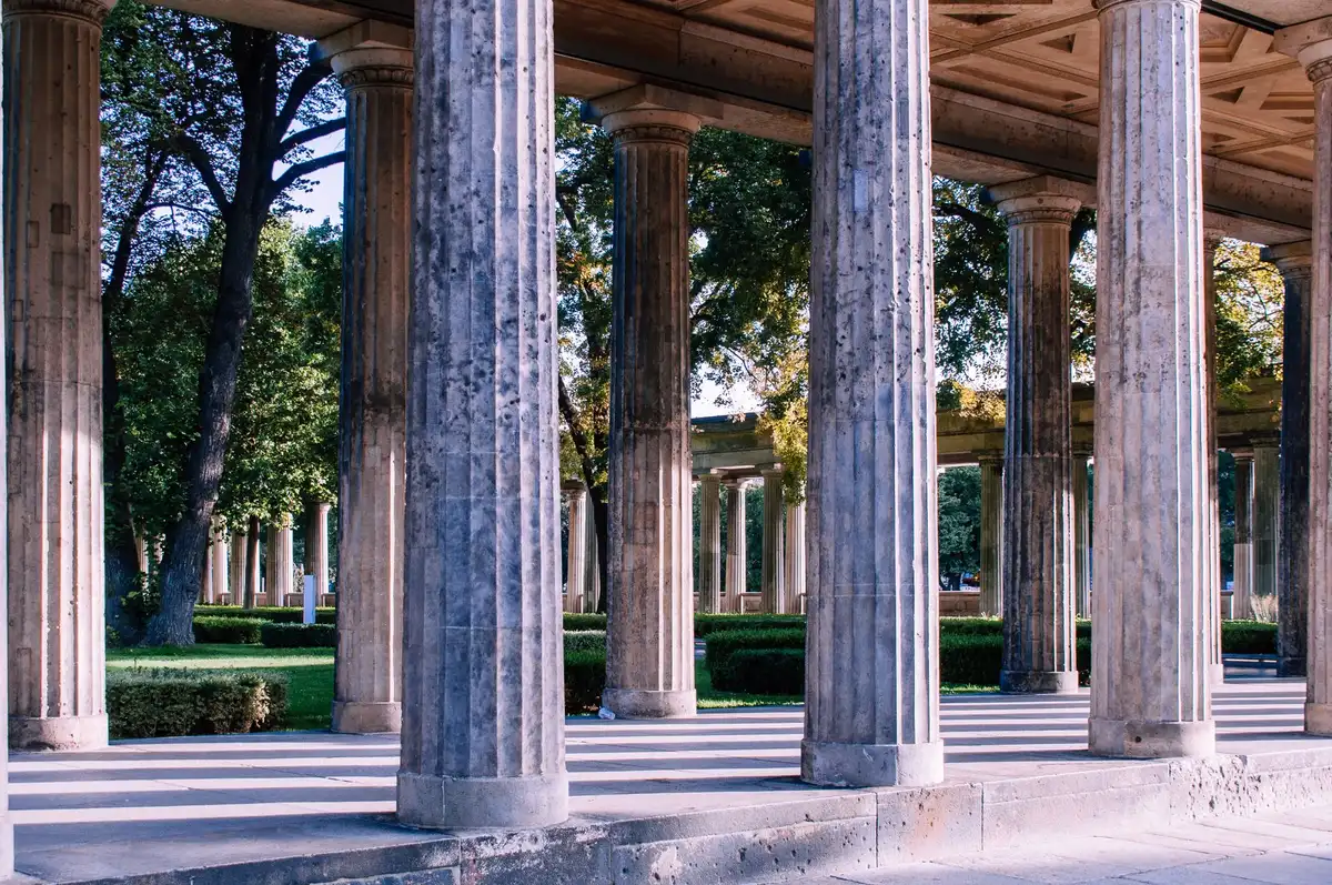 Formal garden with new pathways and planted beds framing a stately white building
