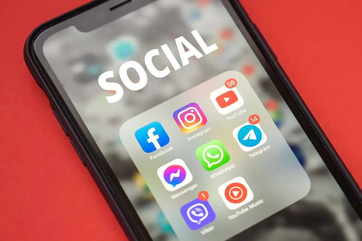 Smartphone screen showing social media posts, comments, and engagement metrics spiking