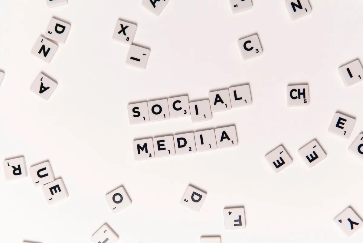 Hands using smartphone to scroll through social media posts and notifications on screen