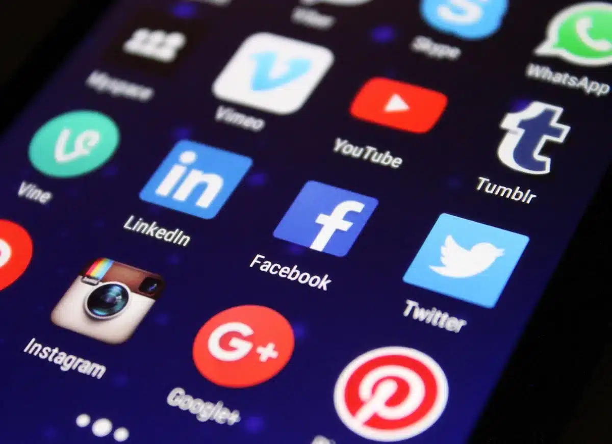 Smartphone screen showing social media comments and reactions to a controversial product announcement