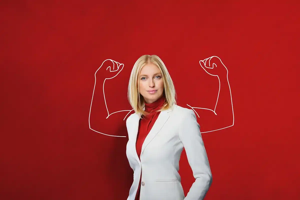 Woman in empowering pose symbolizing personal transformation and independence