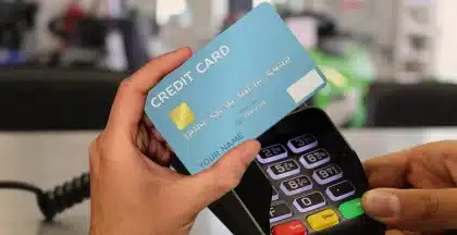 Premium credit card and airline boarding pass on a desk
