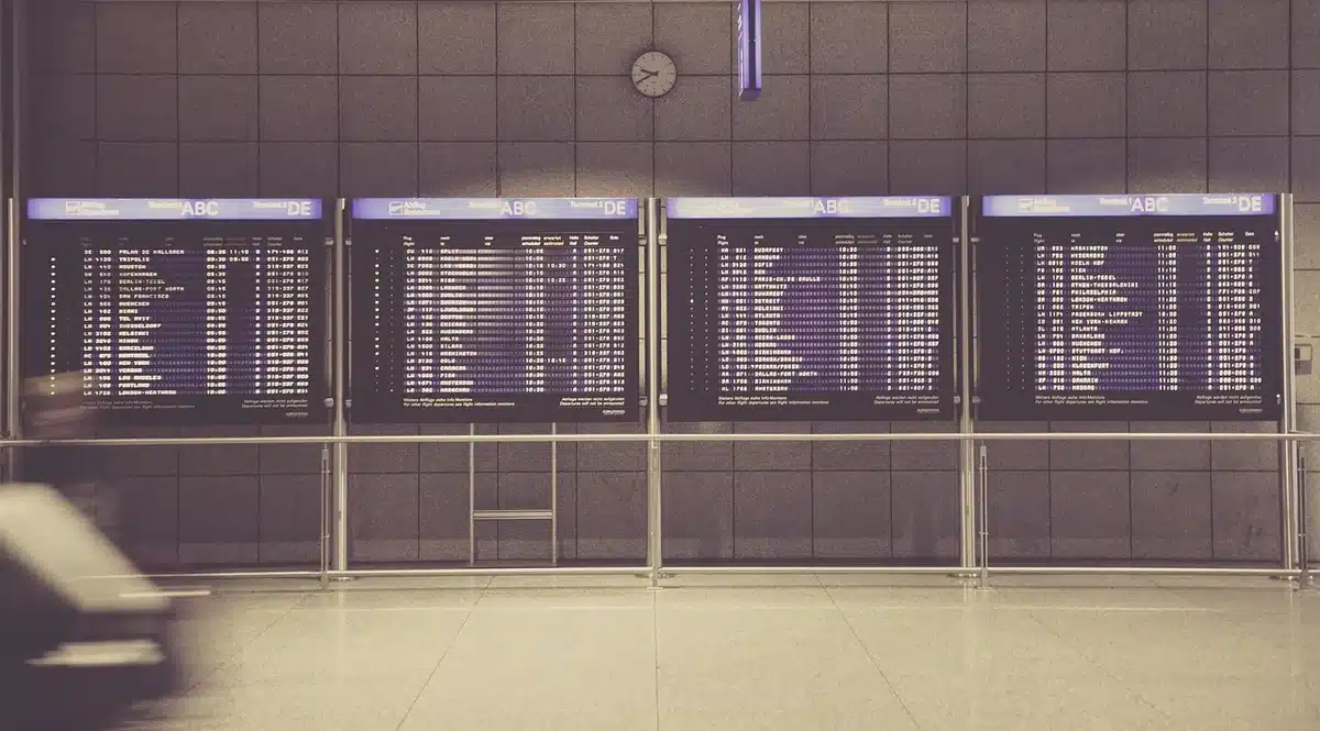 Departure board and empty gate at an airport illustrating removed routes