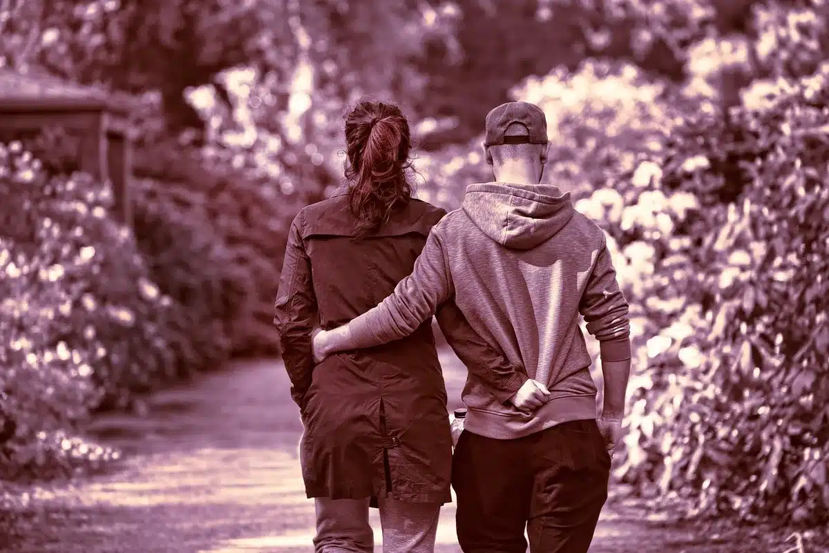 Two people walking in sync at a public ceremony