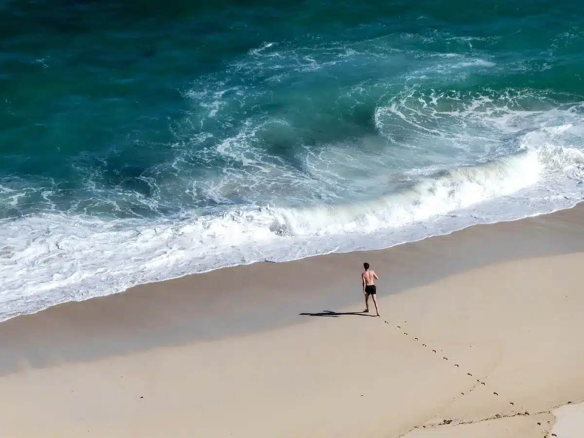 Sunny vacation destination with beach and tourists, representing leisure travel markets
