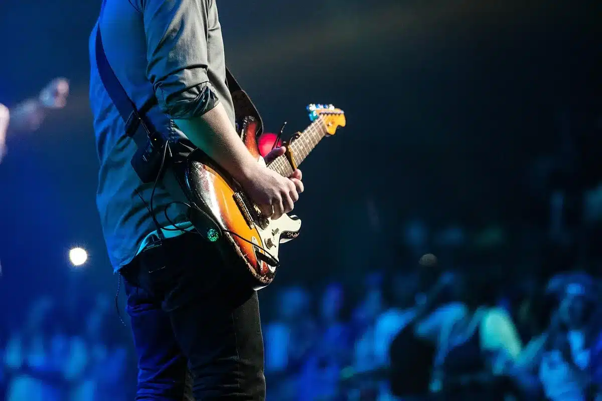A performer on stage radiating warmth and connection with an audience
