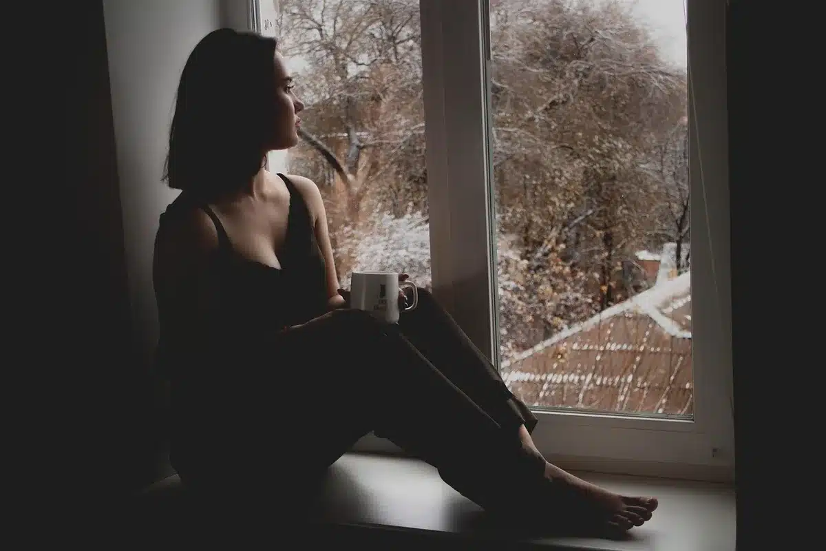 Person in thoughtful pose, reflecting on past experiences