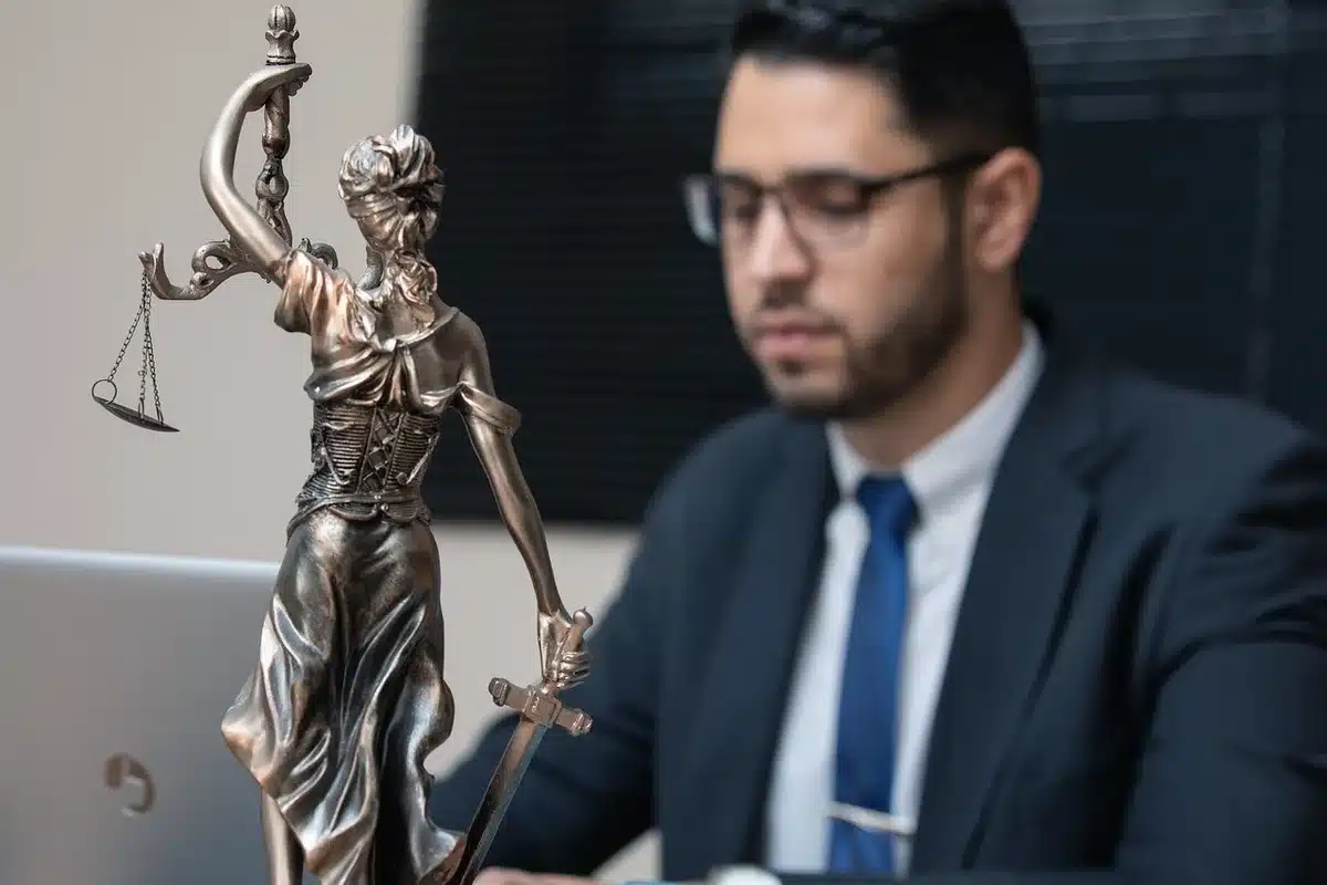 Trembling hands over legal court documents and a restraining order on a desk with soft lighting.