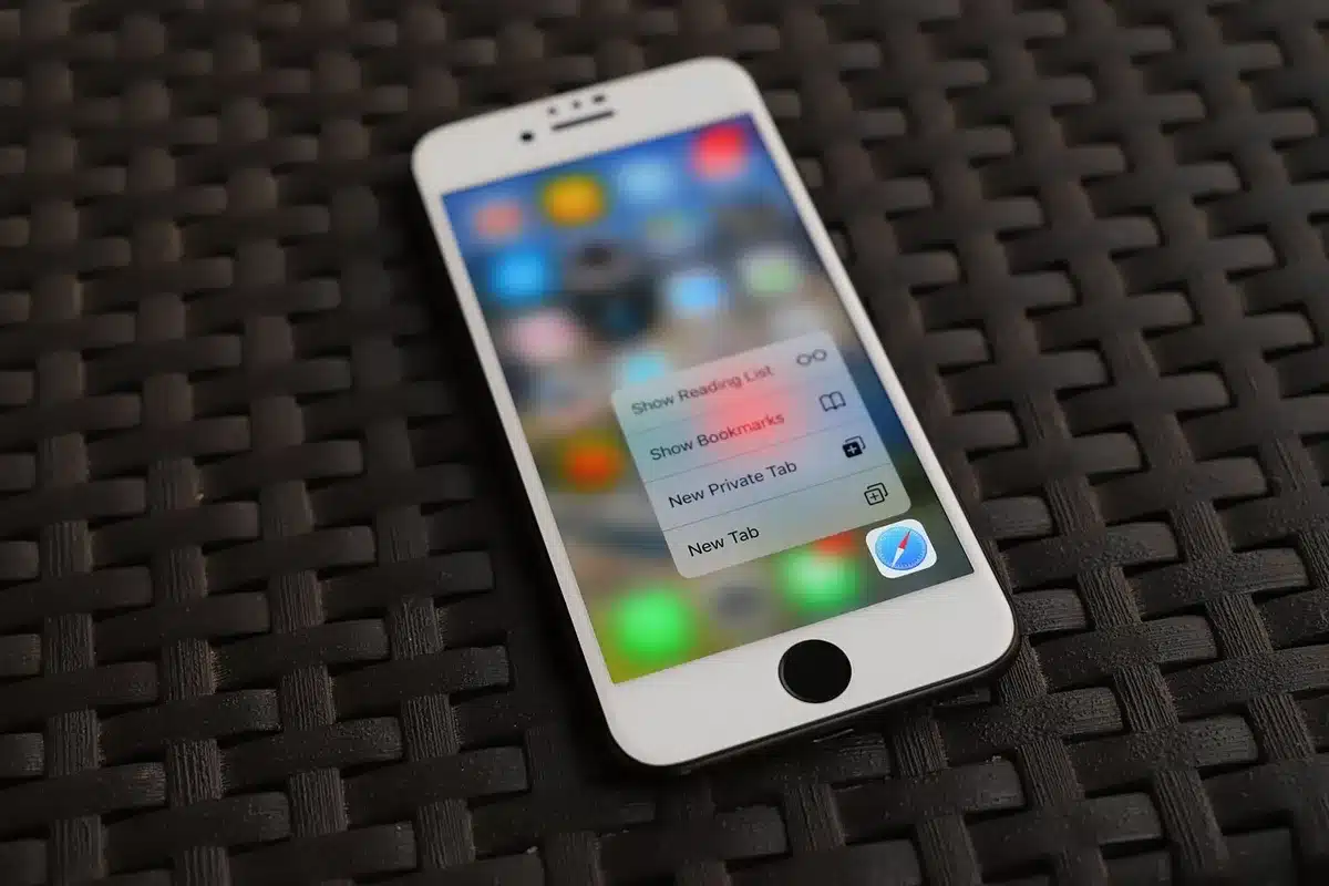 Printed social media screenshots spread on a table with a phone