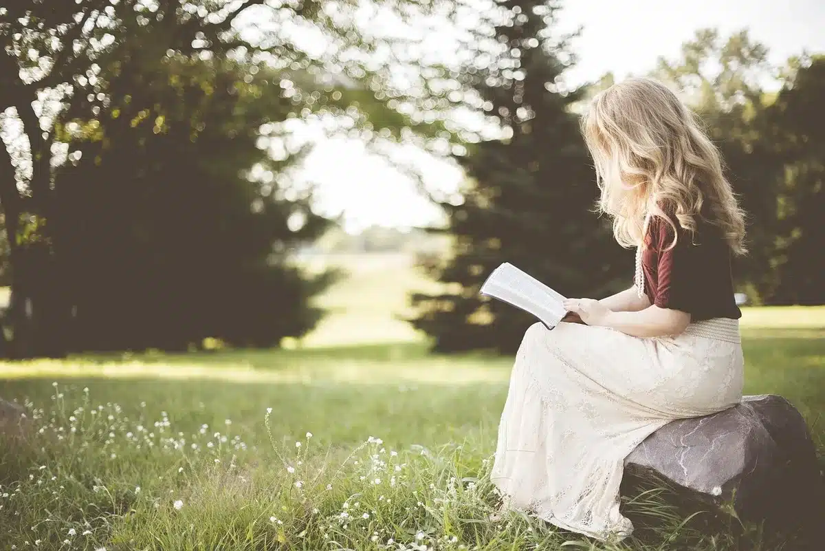 Woman reading a letter by a window, suggesting personal choice and reflection