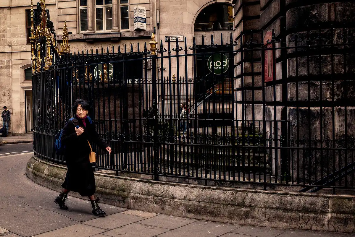 Historic London street with stone buildings and a distant skyline