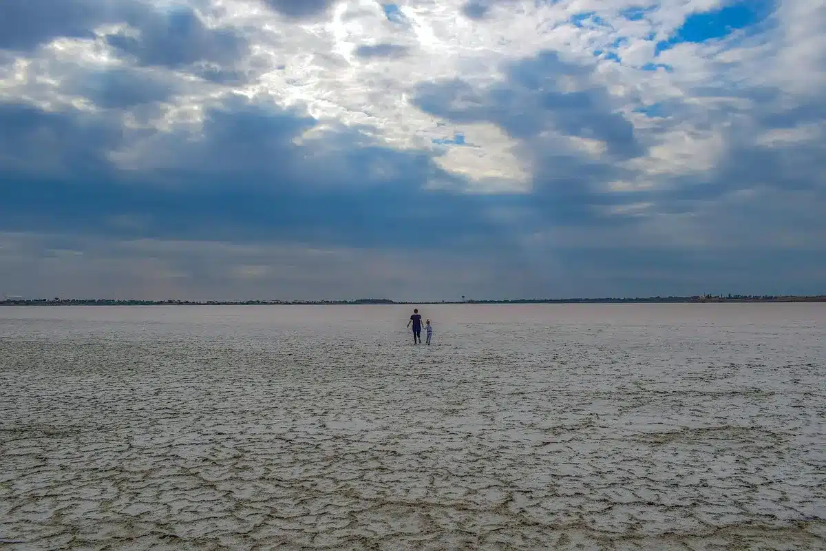 Vivid pink salt lagoons beside white salt flats in the Yucatán