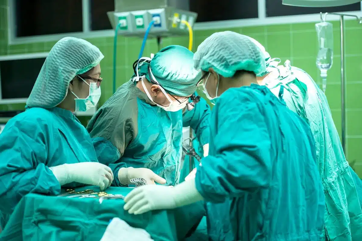 Medical team in an emergency department treating a trauma patient with imaging and monitoring equipment