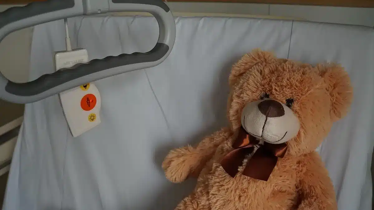 Empty hospital recovery room with chair and folded blanket in soft daylight