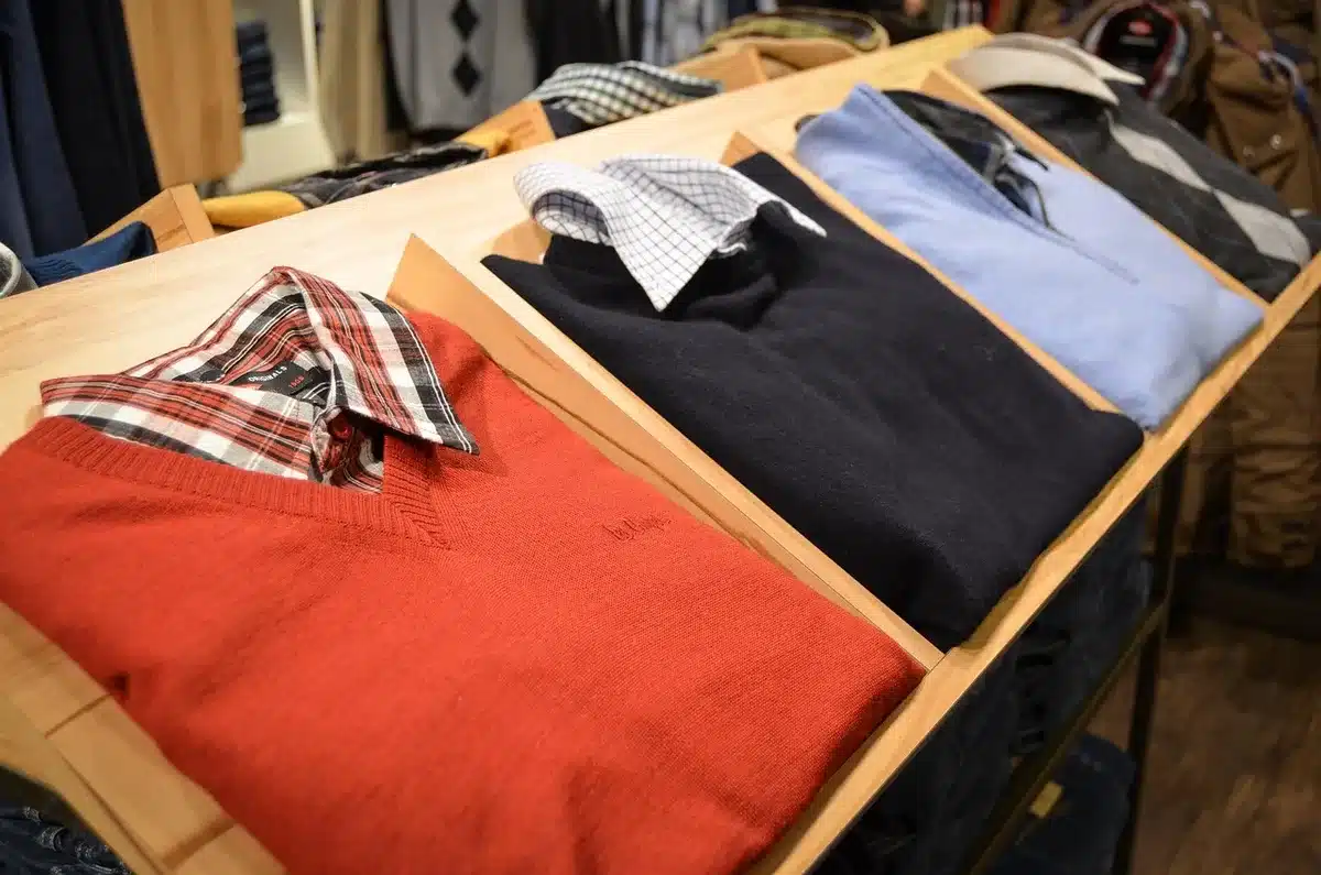 Store employee removing a costume from a shelf