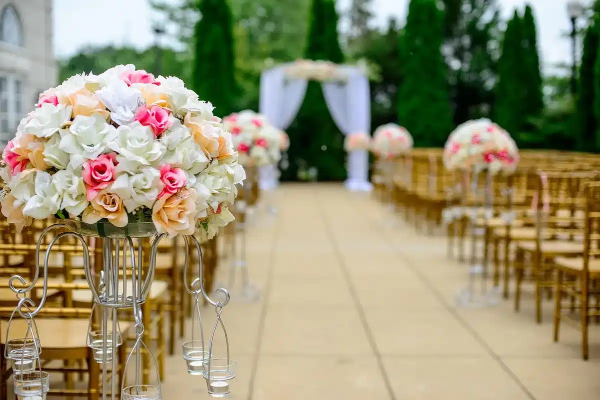 Elegantly decorated arena space with lush floral arrangements and soft lighting creating an intimate garden atmosphere