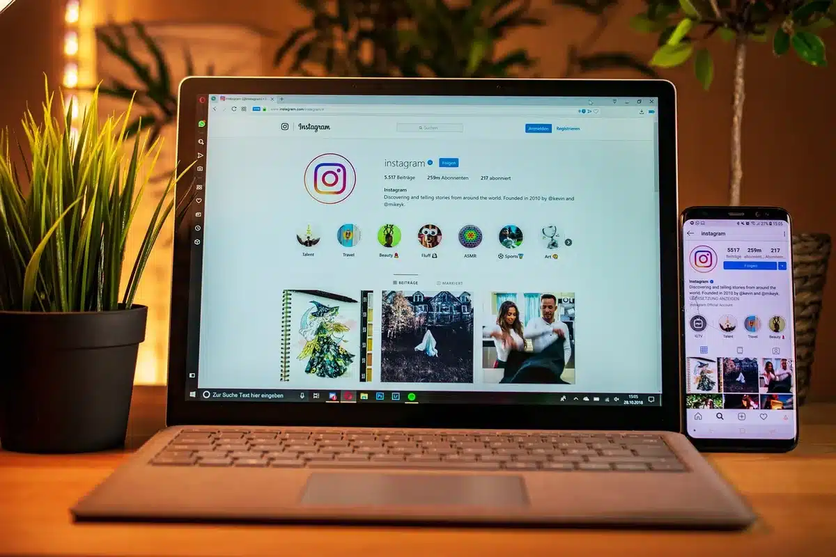 A laptop showing social media trends with notes and moodboard