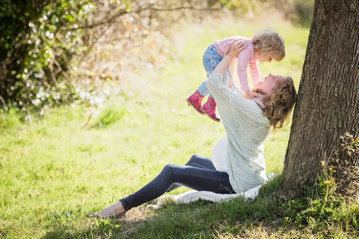 Mother and young child walking in a park, rebuilding after trauma