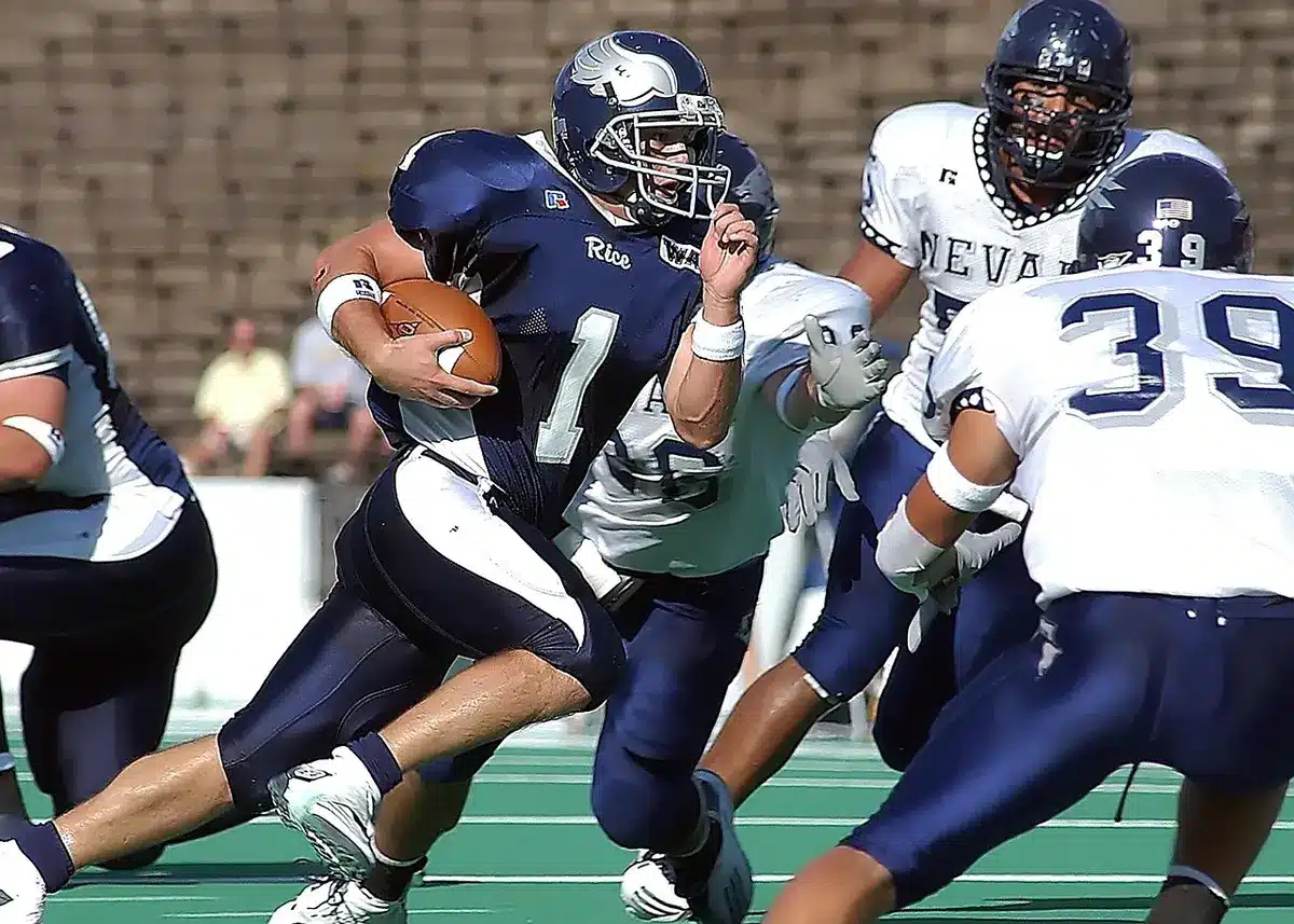 Quarterback dropping back behind an offensive line during a game