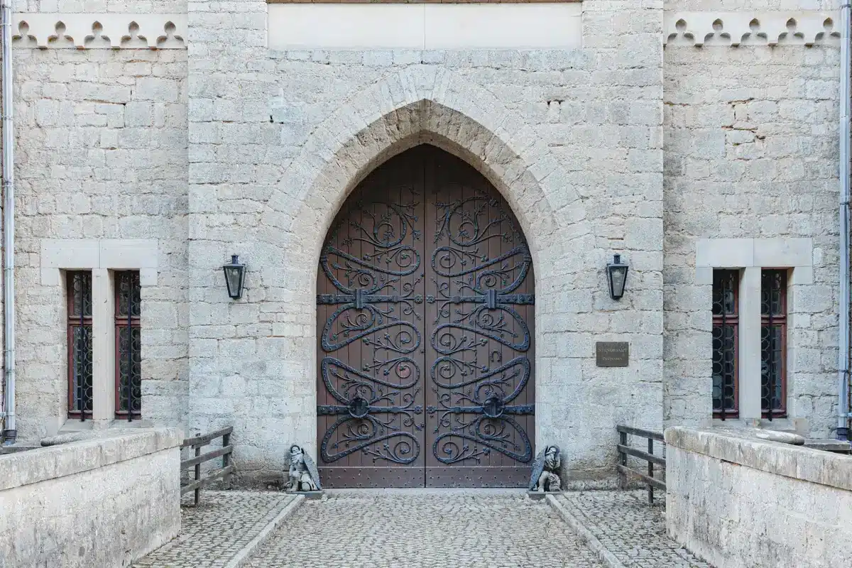 Thick stone walls and gated entrance of a castle illustrating privacy