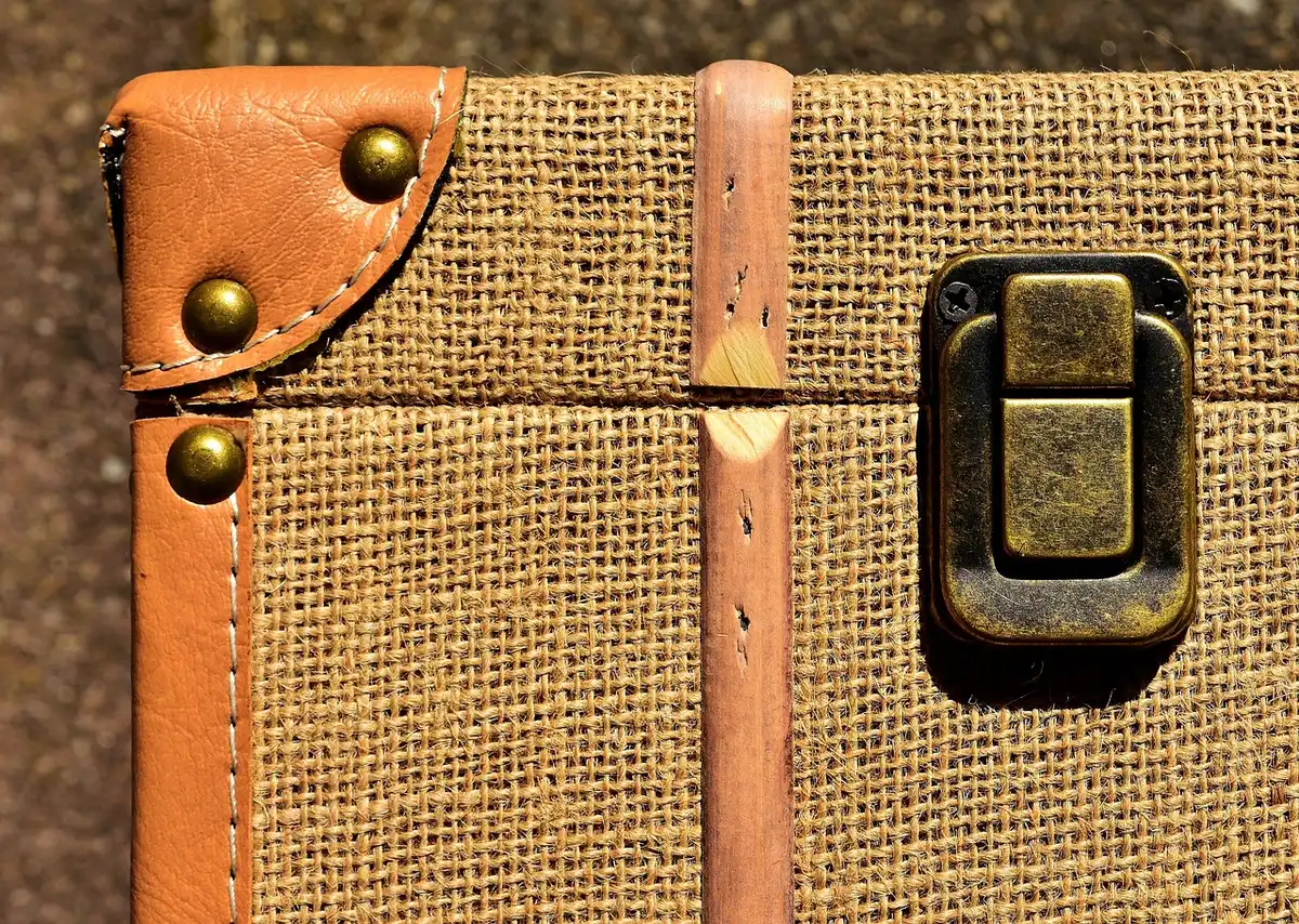 Suitcase interior with wine bottles wrapped in protective sleeves and clothing
