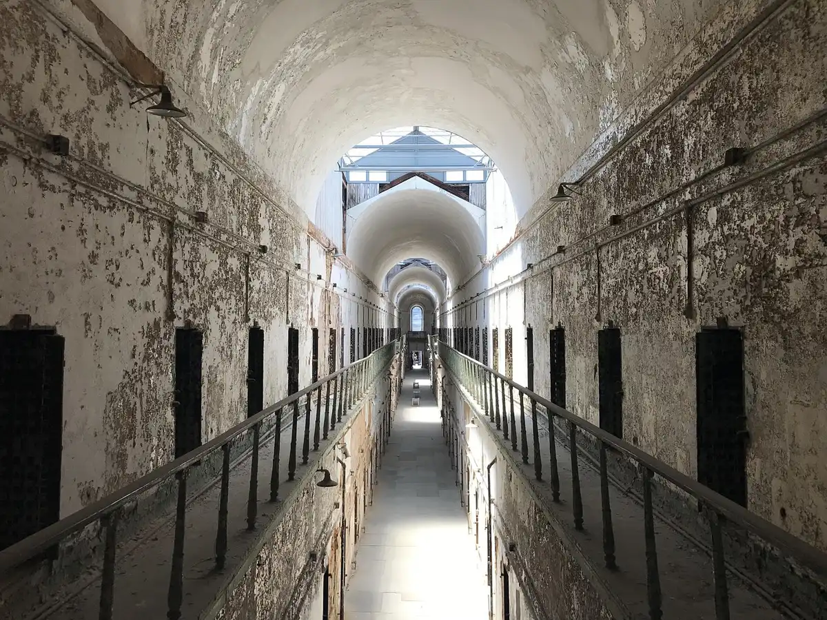 Prison corridor with a food tray and personal items on a shelf