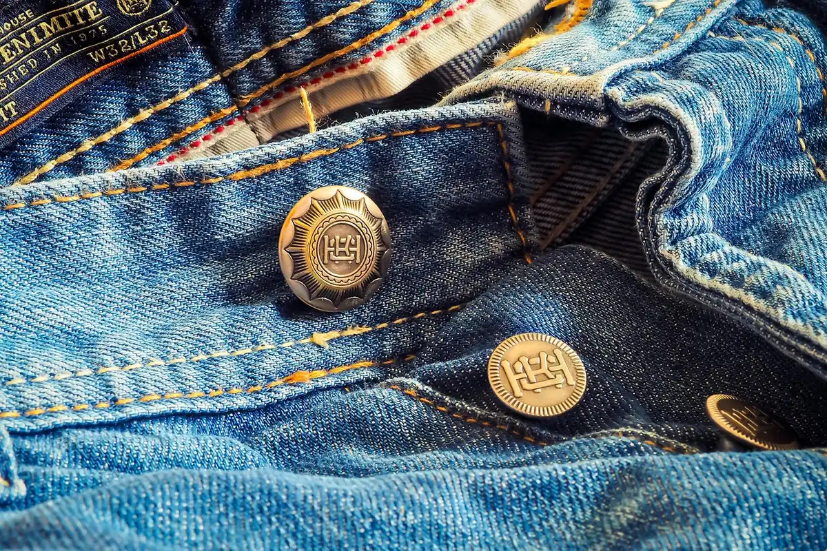 Close-up of denim fabric and stitching highlighting technical performance materials