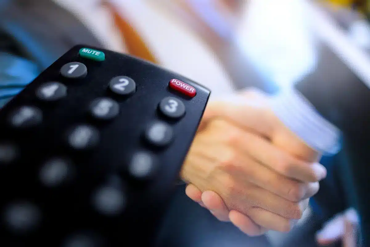 Person holding a remote and streaming on a TV to watch an awards show
