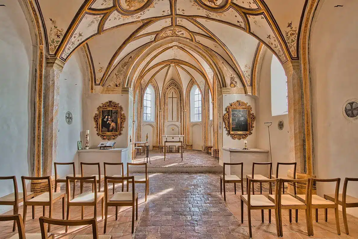 Interior view of a Gothic cathedral's star-vaulted dome and ornate stonework