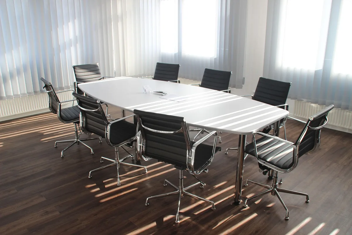 Empty office chair at a conference table after an executive departure