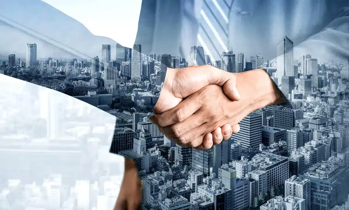 Hands exchanging paperwork at a film market table