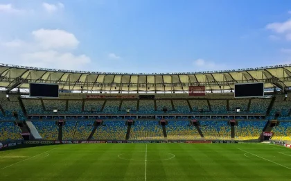 Fans walking through an arena concourse toward the entrance and ticketing stands
