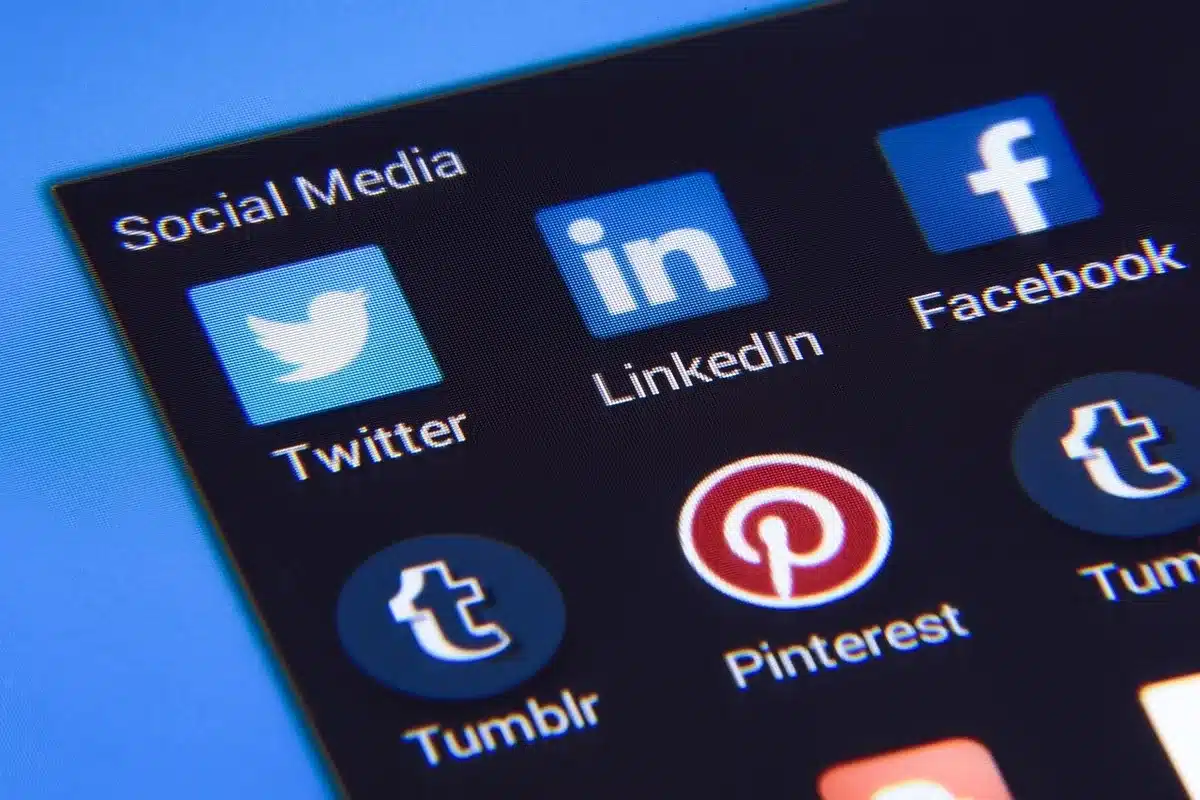 Smartphone on table displaying a viral social media post about a celebrity invite