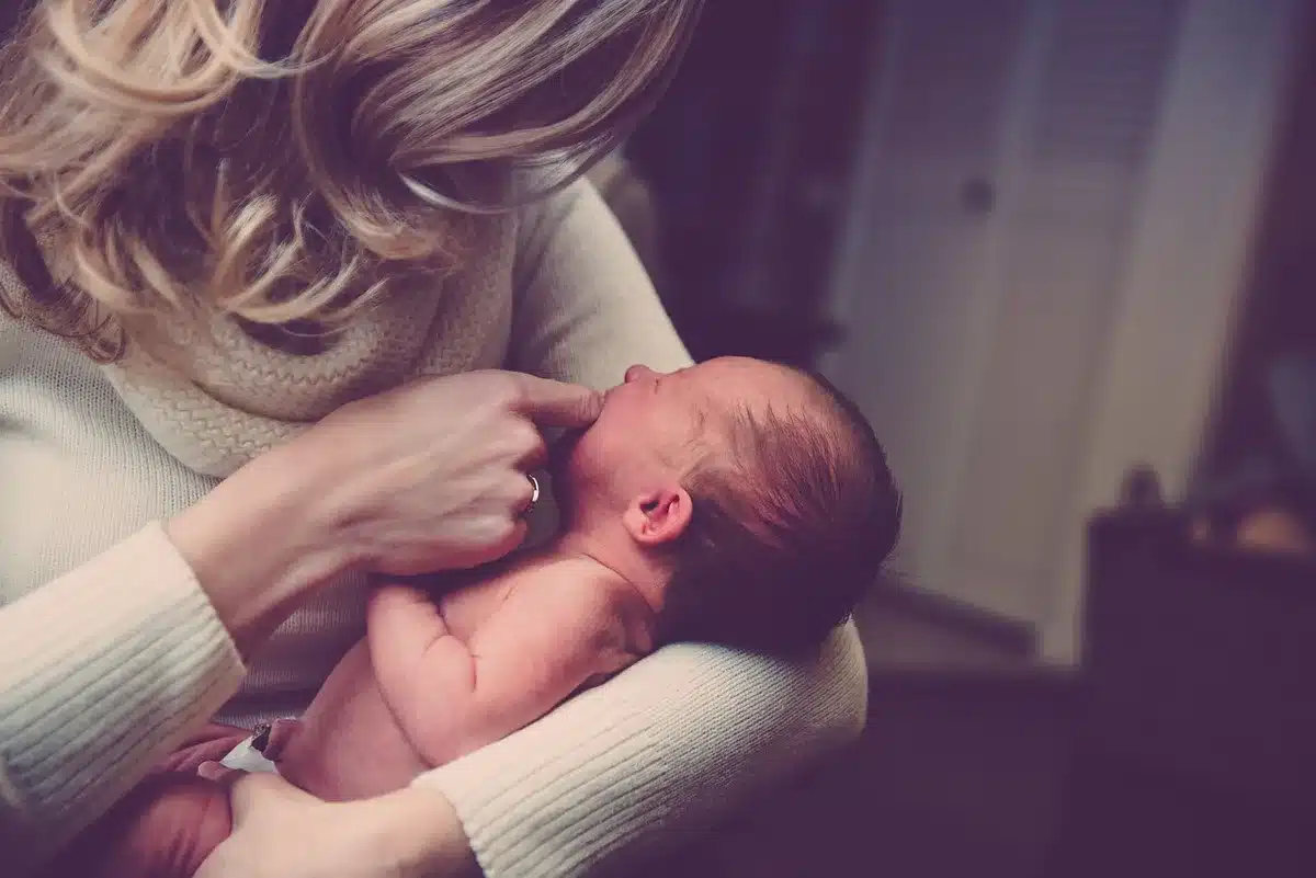 Generic newborn wrapped in blanket representing a social media birth announcement