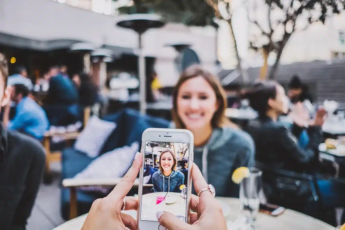 Hands holding phones showing social media reactions at home