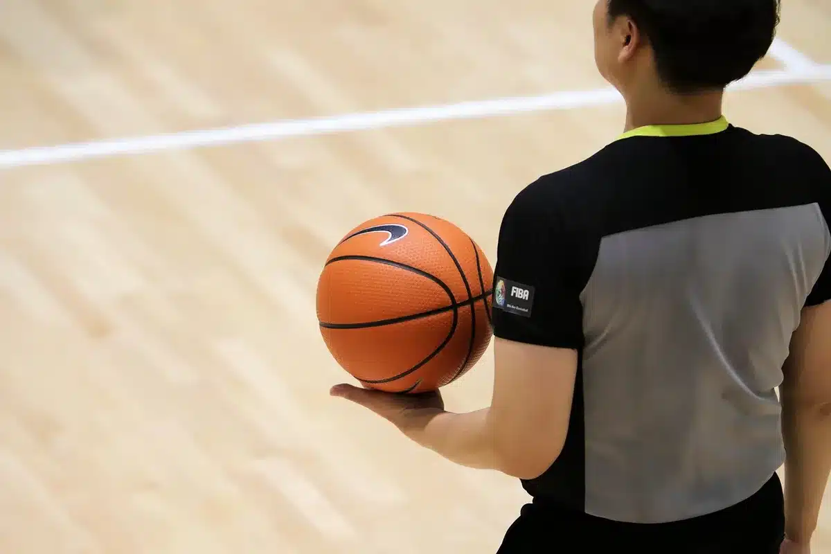 Young player practicing alone on court, focused on shooting